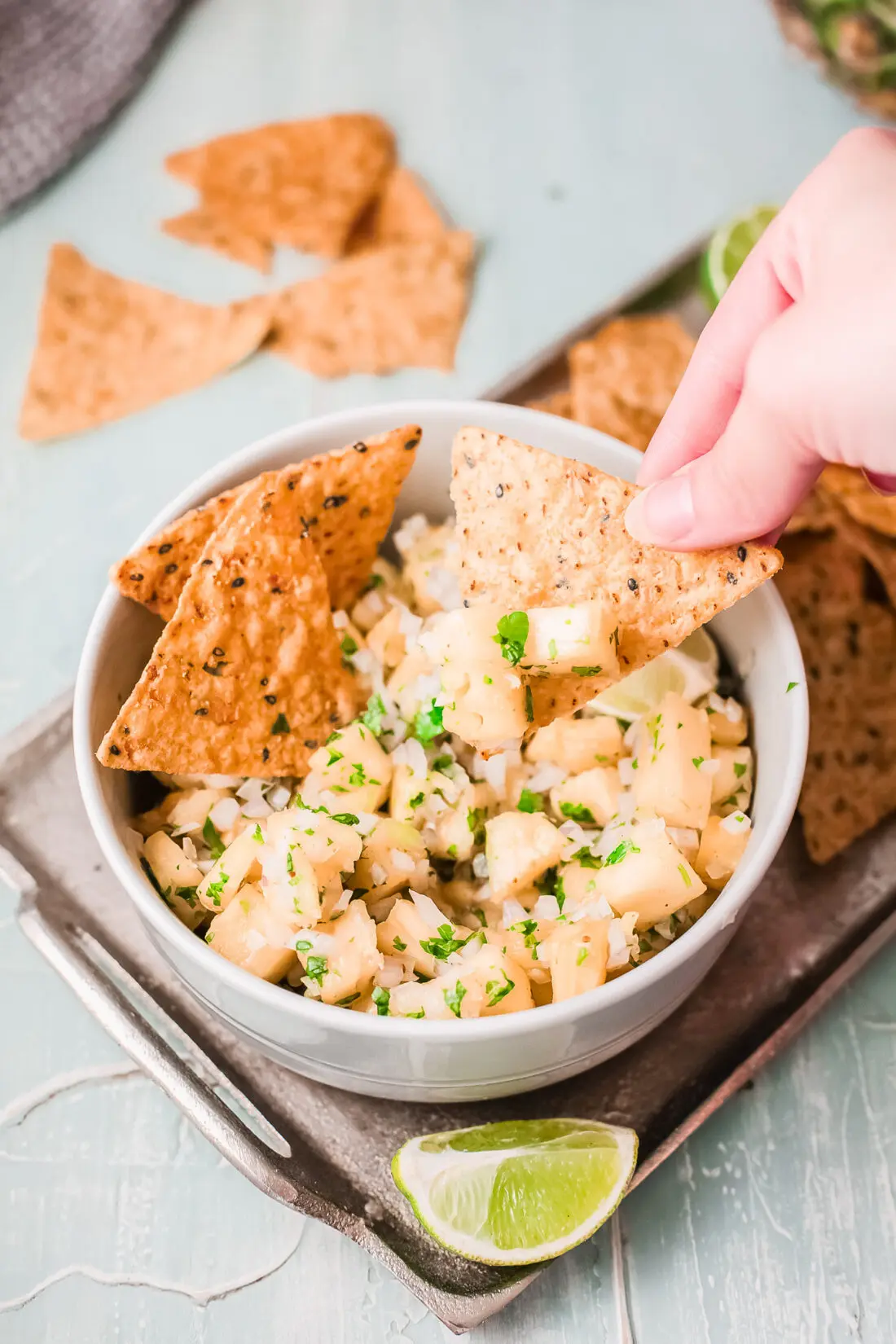A fresh and simple pineapple salsa recipe that goes great with tacos and tortilla chips. Made with fresh-cut pineapple, peppers, onions, lime juice, and cilantro. It's an easy-to-make dip recipe that pairs well with other summertime recipes.