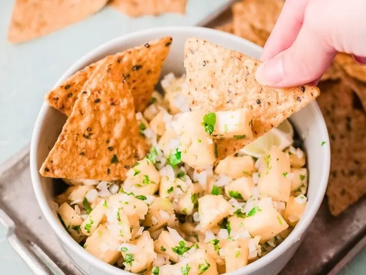 A fresh and simple pineapple salsa recipe that goes great with tacos and tortilla chips. Made with fresh-cut pineapple, peppers, onions, lime juice, and cilantro. It's an easy-to-make dip recipe that pairs well with other summertime recipes.