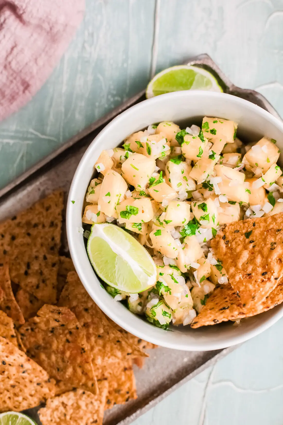 Closeup Overhead shot of my pineapple salsa dip in bowl with tortilla chips. On platter and ready to be served.
