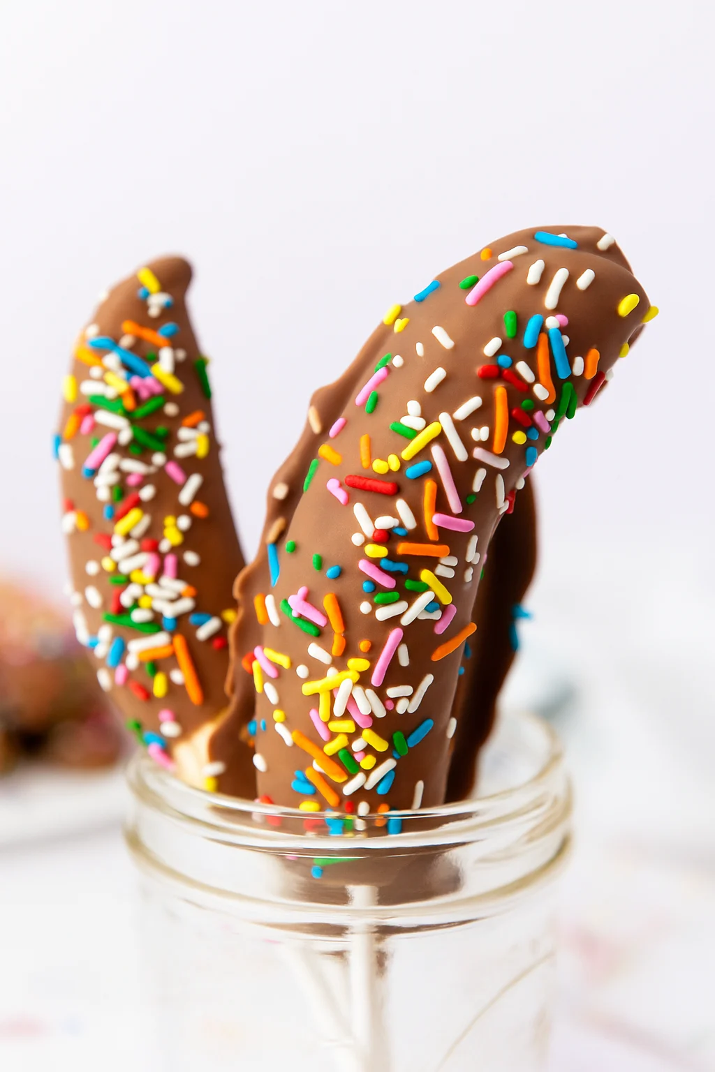 These Chocolate Dipped Bananas are an easy afterschool snack that kids love! This fun and kid friendly snack recipe takes just minutes to make and is perfect for busy afternoons, playdates, or a sweet treat anytime.