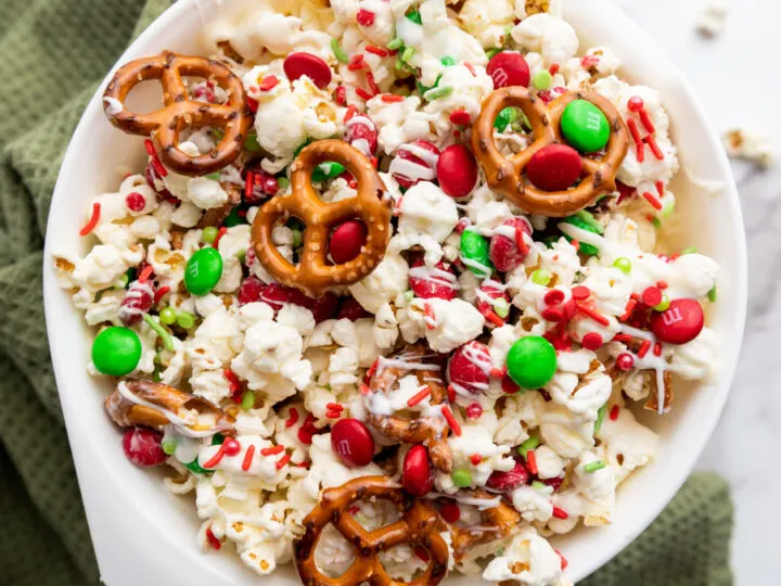 This Christmas Popcorn Snack Mix is the ultimate merry treat, packed with sweet candy melts, crunchy pretzels, festive M&Ms, and just the right sprinkle of holiday magic. It's colorful, crunchy, and completely addictive! Perfect for holiday parties or for everyday snacking.